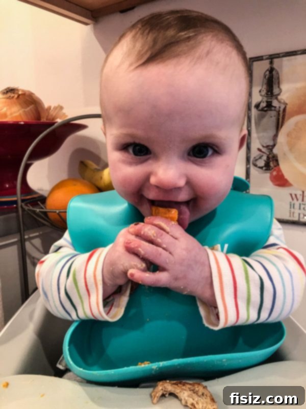 Half a Year with Charlie 10 Baby Charlie enjoying another solid food, demonstrating her growing independence with eating.
