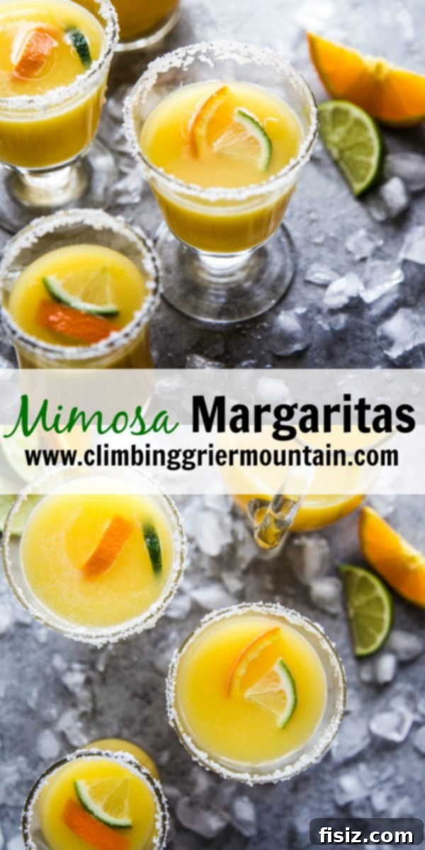 Sparkling Orange Tequila 13 A Mimosa Margarita in a clear glass, garnished with a lime slice, on a marble surface.