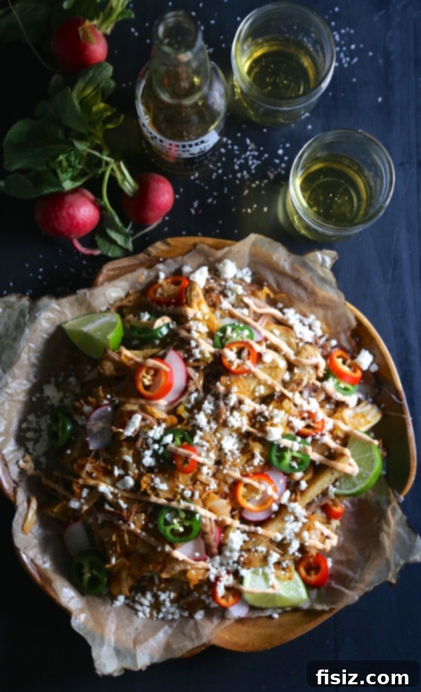 Sparkling Orange Tequila 8 Slow Cooker Carnitas Kimchi Fries topped with sauce and green onions.