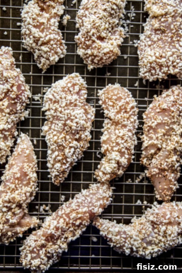 Sticky Korean BBQ Baked Chicken Fingers 5 Korean BBQ Baked Chicken Fingers arranged neatly on a serving platter with dipping sauce.