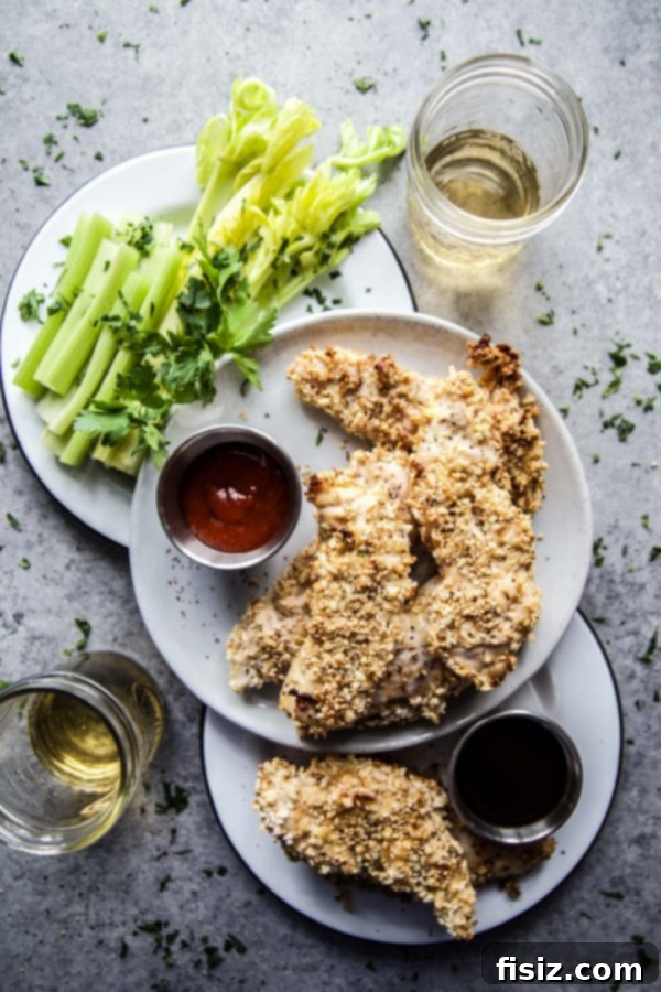 Sticky Korean BBQ Baked Chicken Fingers 6 A bowl of Korean BBQ sauce with a plate of baked chicken fingers in the background.