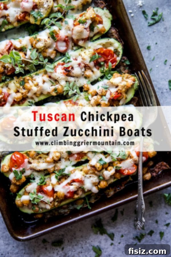 Zucchini Boats with Tuscan Chickpea Filling 8 Two finished Tuscan Chickpea Stuffed Zucchini Boats on a plate, garnished with fresh basil.
