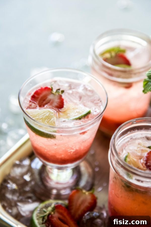 Crimson Gin Tonic 3 Hands holding a Strawberry Gin and Tonic in a tall glass, garnished with fresh fruit