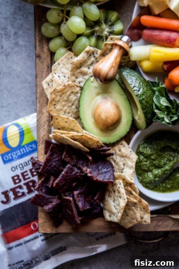 The Perfect Summer Grazing Platter 7 Detailed shot of O Organics almonds, beef jerky, and Open Nature bar on a snack board