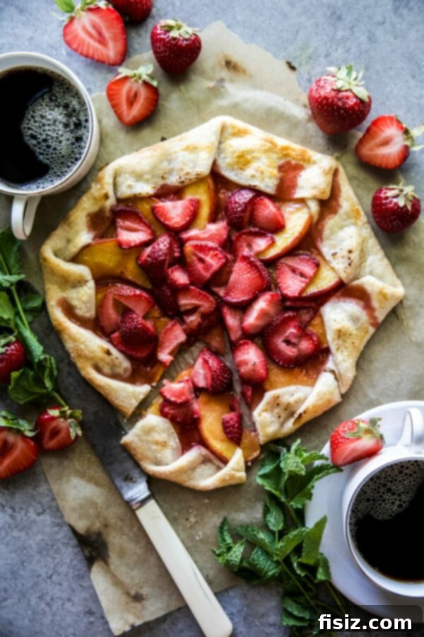 Freshly baked Strawberry-Peach Galette on a rustic wooden surface