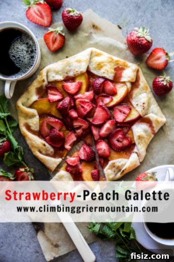 A slice of Strawberry-Peach Galette, served with a scoop of vanilla ice cream