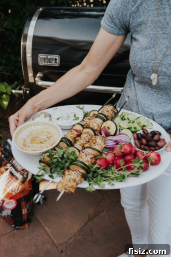 Greek Chicken Souvlaki 2 Flavorful Greek Chicken Skewers grilled to perfection on a Weber SmokeFire Grill, ready to be served.