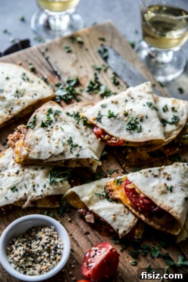 Two Everything BLT Baked Quesadillas, golden brown and crispy, resting on a rustic wooden board, ready to be served.