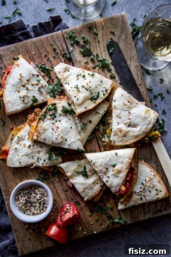 A close-up shot of a single Everything BLT Baked Quesadilla, showcasing its golden crust and the melted cheese oozing from the edges.