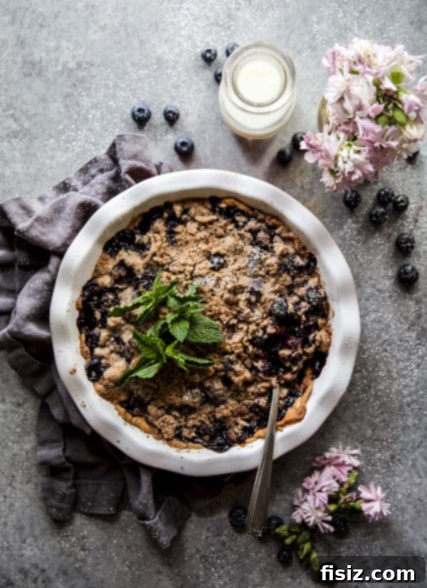 Cardamom-Kissed Blueberry Crumble Pie 6 Full Cardamom Blueberry Crumble Pie cooling on a wire rack