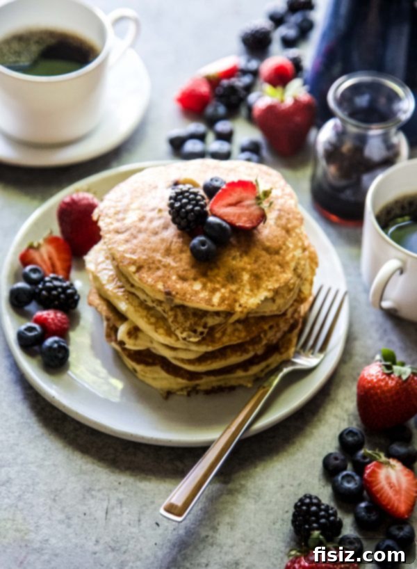Almond Berry Bliss Stacks 6 Stack of Mixed Berry Almond Pancakes with fresh berries and a drizzle of syrup