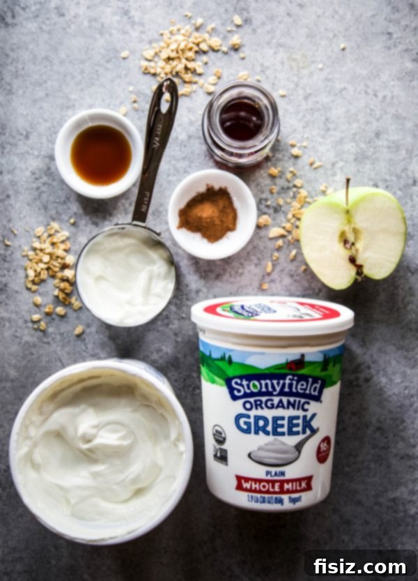 A person holding a frozen apple cinnamon yogurt cup, showcasing the autumn-inspired snack.