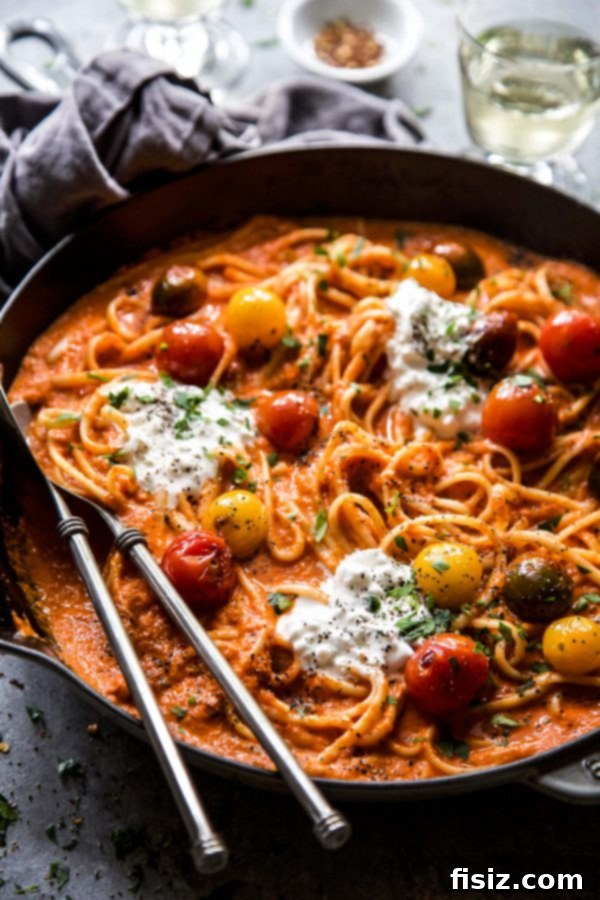 Indulgent Roasted Red Pepper Alfredo with Burst Tomatoes and Creamy Burrata 3 Overhead shot of Roasted Red Pepper Alfredo pasta with a generous helping of burrata cheese.