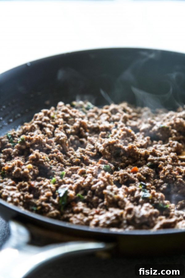 Thai Basil Beef Zucchini Boats 5 Raw ground beef in a skillet, ready to be cooked and browned for the recipe.