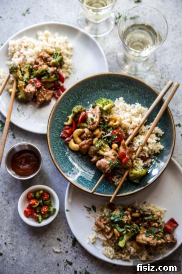 Sticky Honey Garlic Chicken Stir Fry 5 Plated Easy Honey Garlic Chicken Stir Fry served over brown rice, garnished with fresh basil.