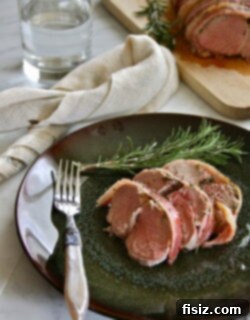 Final plated Rosemary Bacon-Wrapped Pork Tenderloin, ready for serving.