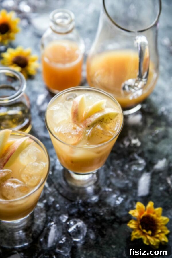 Multiple Apple Bourbon Ginger Spritz cocktails in elegant glasses, ready for a fall gathering