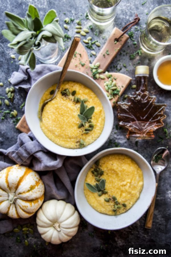 Creamy Maple Roasted Pumpkin Grits 6 A close-up shot of Maple Roasted Pumpkin Grits in a bowl, with a spoon ready to serve.