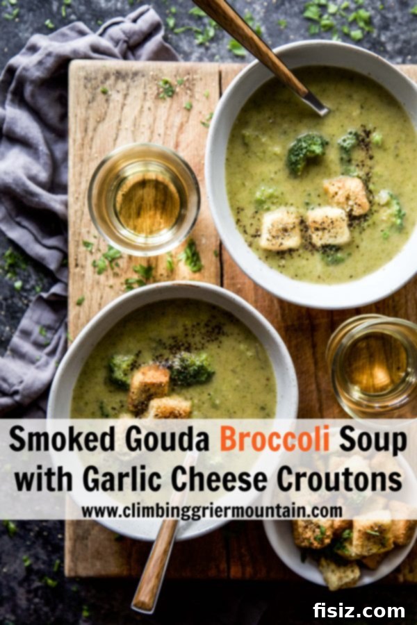 Creamy Smoked Gouda Broccoli Soup with Crispy Garlic Cheese Croutons 8 Two bowls of Smoked Gouda Broccoli Soup with croutons on a table, with a green tea cup in the background.