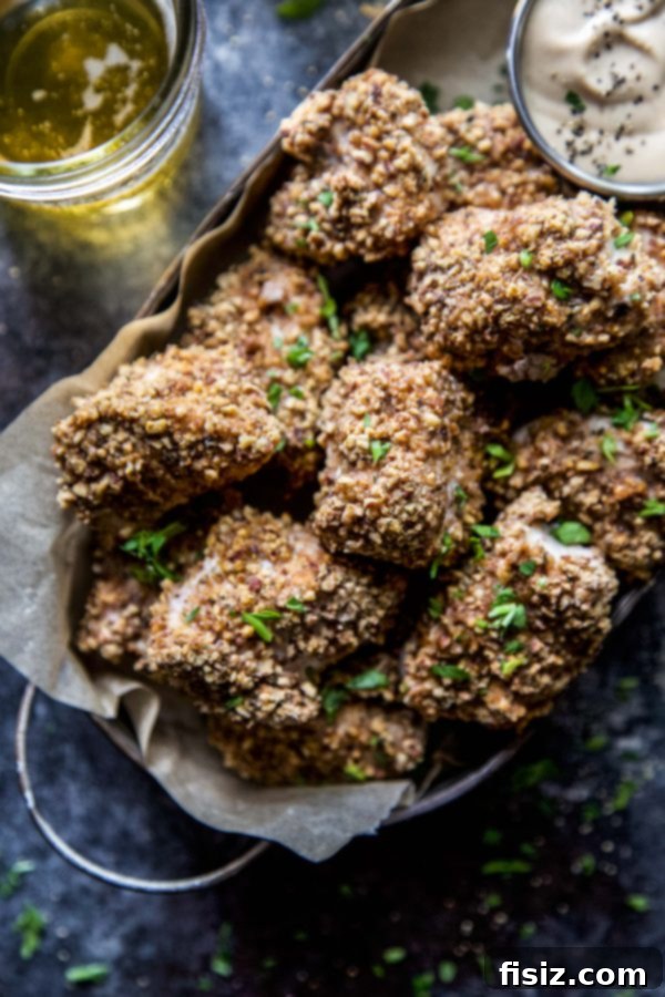 Spiced Pecan Chicken Bites & Chipotle Mustard Dip 2 Spiced Pecan Baked Chicken Nuggets with Chipotle Mustard in a bowl, ready to be served.