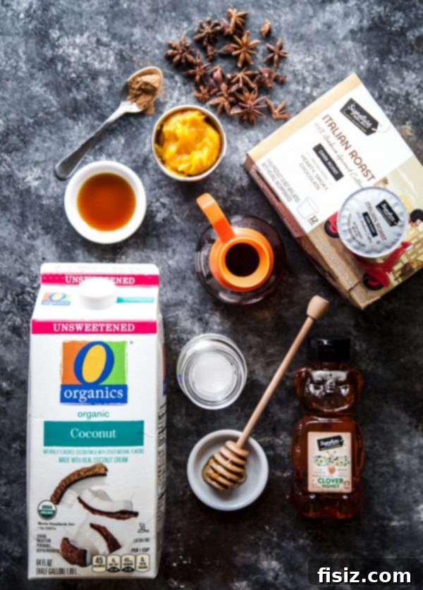 Spiced Coconut Pumpkin Latte 4 Key ingredients for Coconut Pumpkin Latte displayed: coffee pods, coconut milk, and honey