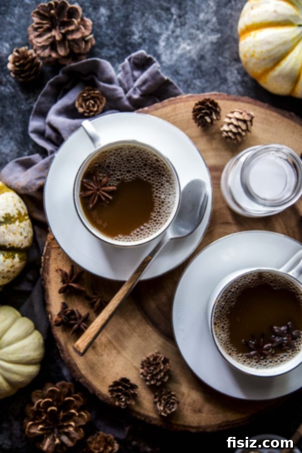 Spiced Coconut Pumpkin Latte 7 Two glasses of Coconut Pumpkin Latte with a cozy autumn background