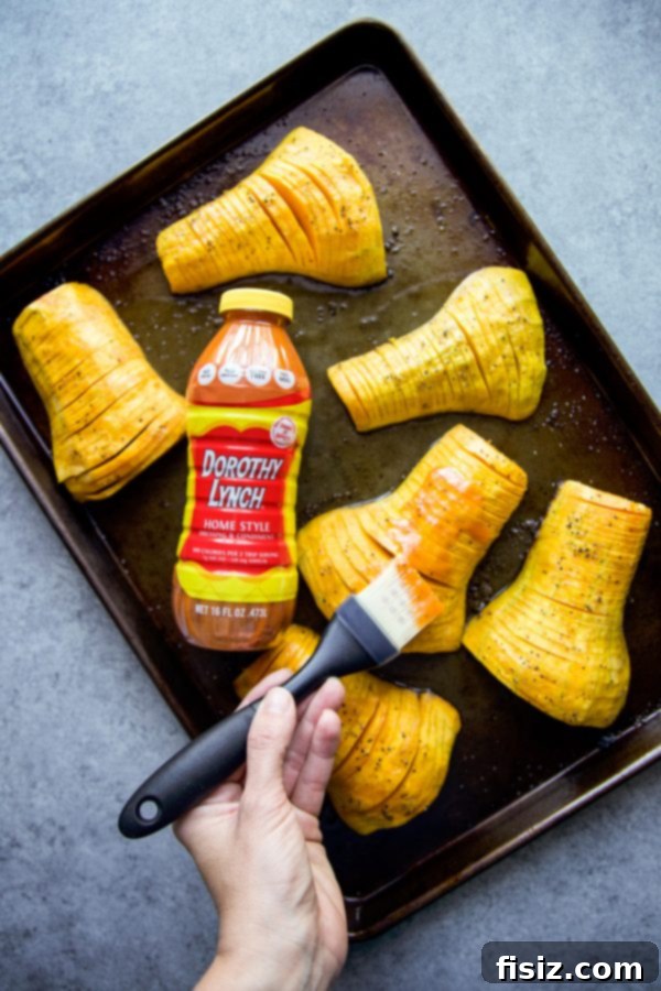 Dorothy Lynch Glazed Hasselback Butternut Squash 5 Close-up of cooked Hasselback Butternut Squash garnished with rosemary and pecans
