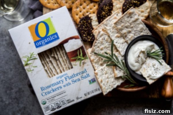 Festive Crackers: 3 Easy DIY Ideas 6 A bowl of creamy honey whipped goat cheese dip with Rosemary Flatbread Crackers and fresh rosemary garnish.
