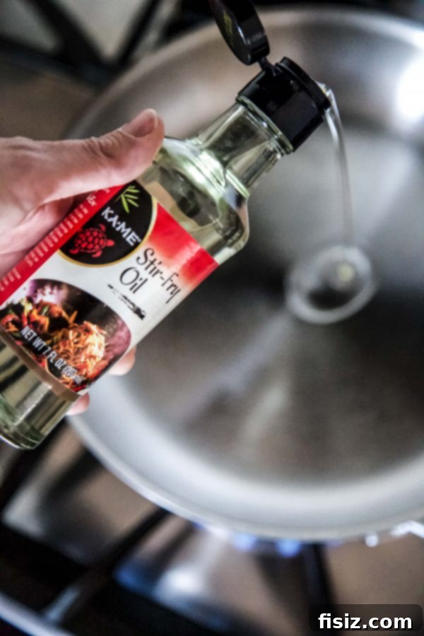 Effortless Kung Pao Chicken 5 KA-ME Stir-Fry Oil being used in a wok for cooking