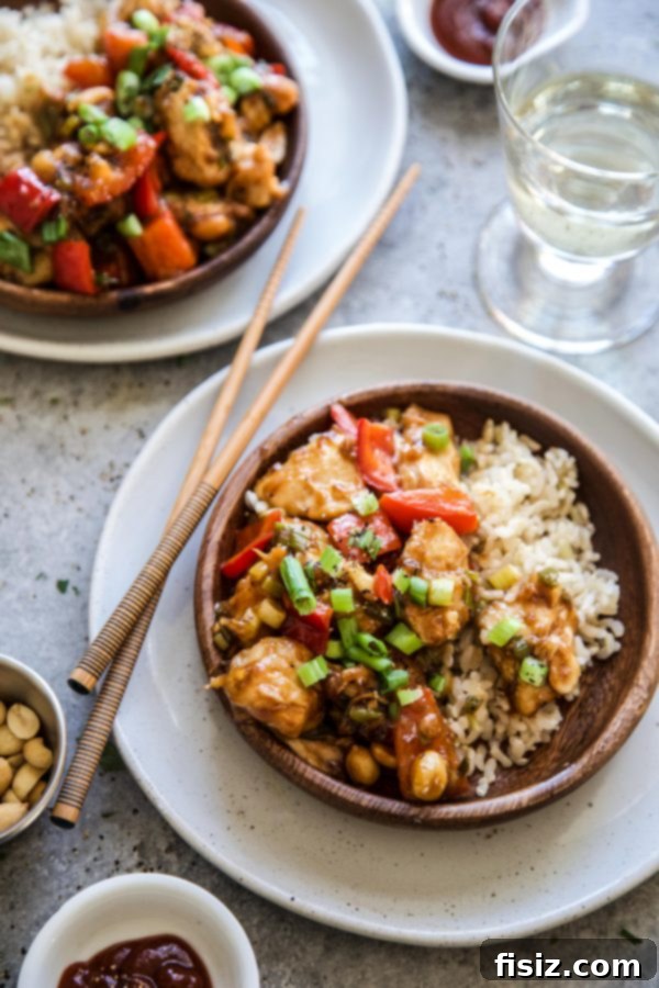 Effortless Kung Pao Chicken 7 Plated Easy Kung Pao Chicken served with rice and garnished with parsley