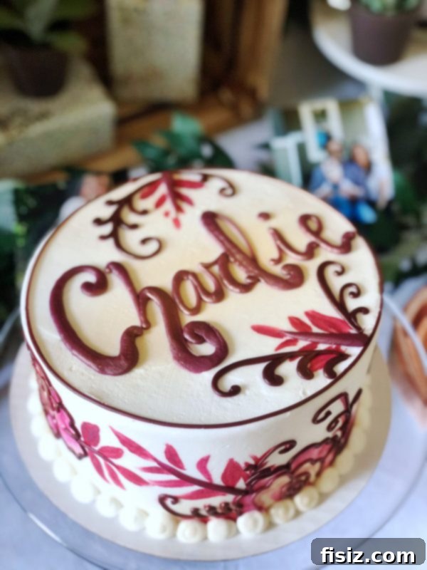 Our First Year with Charlie 11 A beautifully decorated first birthday cake with a golden cake topper and themed decor.