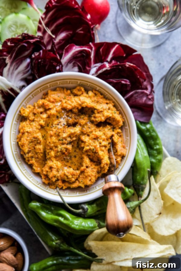 Smoky Roasted Carrot Spread 6 A beautifully arranged mezze platter featuring Easy Smoky Carrot Dip, fresh vegetables, and crackers, showcasing its appeal as a versatile and colorful appetizer.