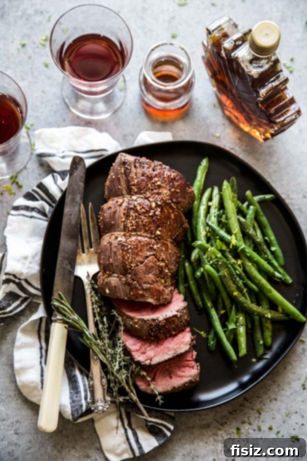 Signature Maple-Mustard Roasted Beef Tenderloin 3 roasted beef tenderloin on a plate with green beans