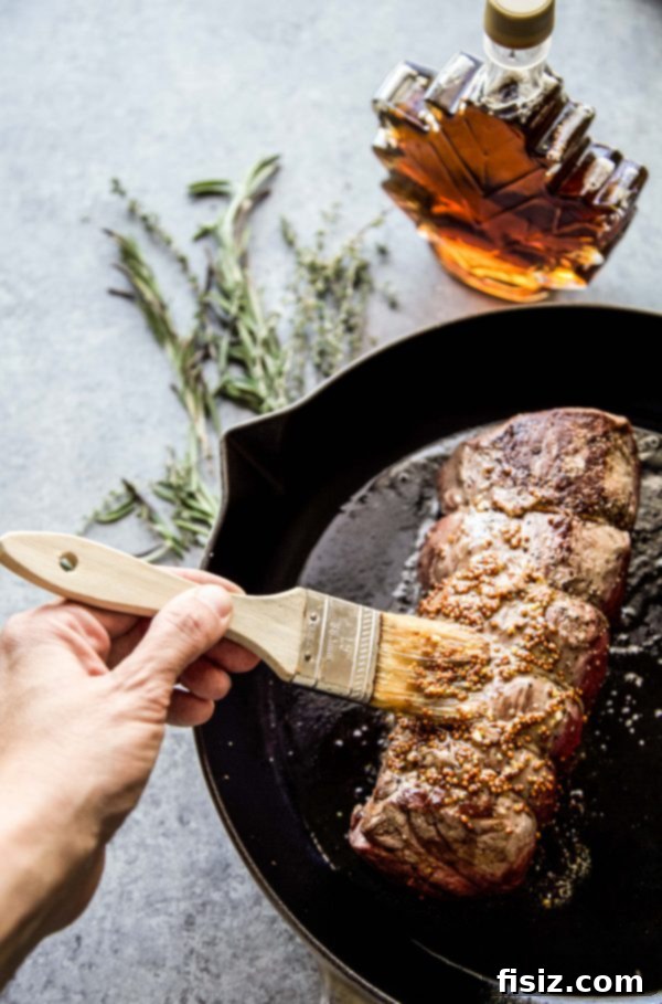 Signature Maple-Mustard Roasted Beef Tenderloin 5 maple mustard glaze being brushed onto beef tenderloin