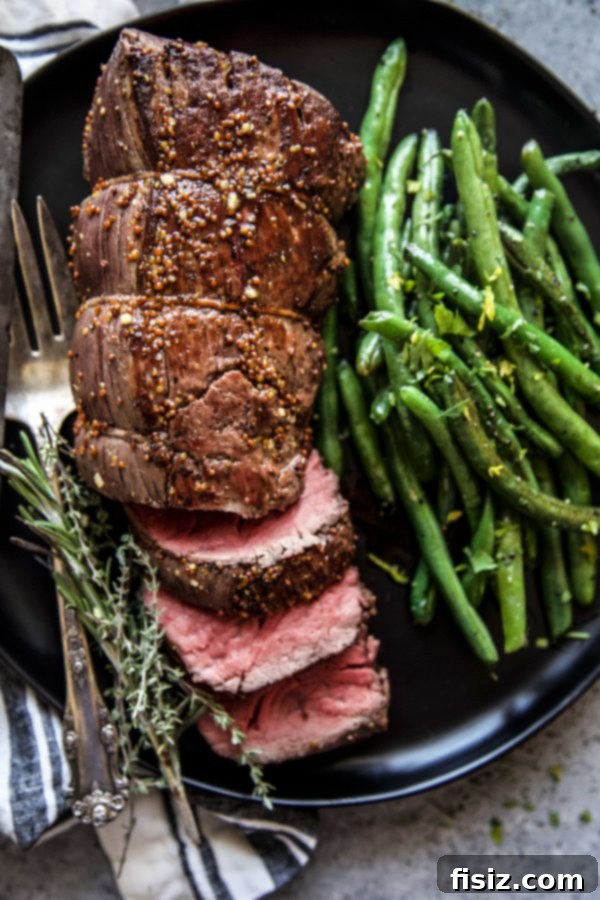Signature Maple-Mustard Roasted Beef Tenderloin 6 roasted beef tenderloin on a plate with green beans