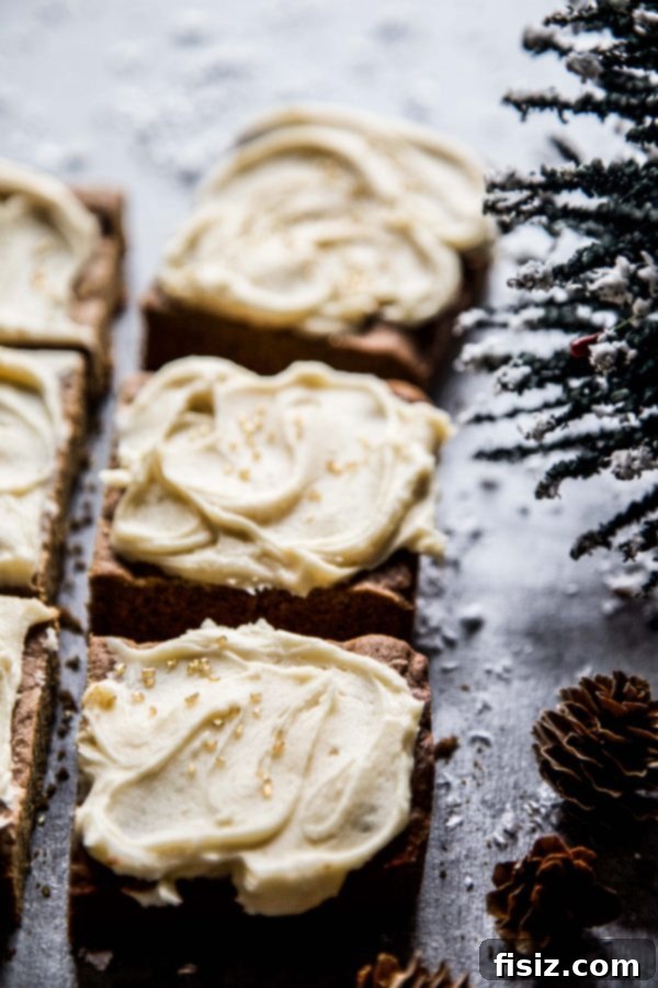 Golden Gingerbread Bars with Creamy Caramel Frosting 5 Beautifully frosted Gingerbread Cookie Bars with shimmering caramel, adorned with festive sprinkles, served on an elegant platter.