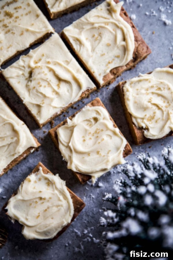 Golden Gingerbread Bars with Creamy Caramel Frosting 6 A close-up shot of Gingerbread Cookie Bars with Caramel Frosting, beautifully presented and garnished with festive sprinkles, ready to be enjoyed.