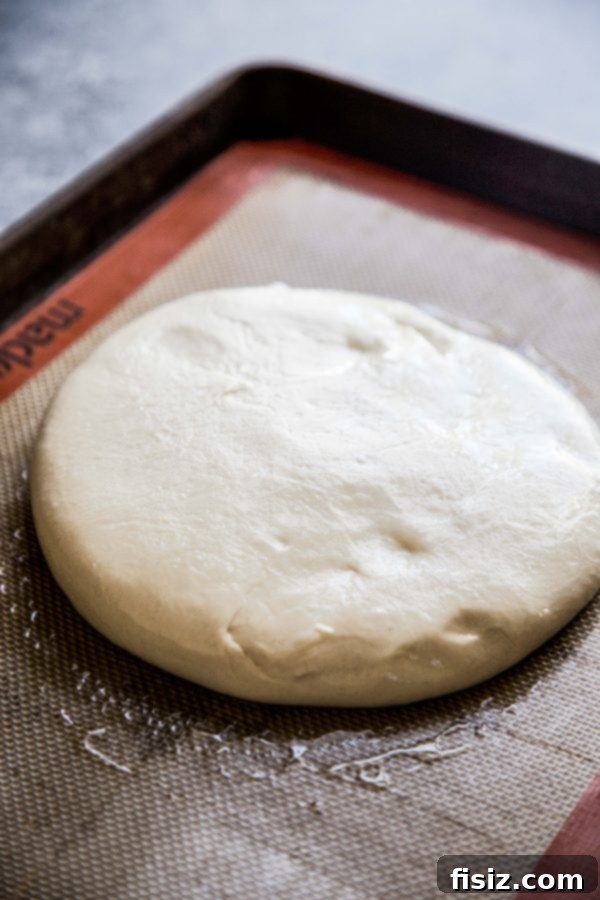 Simple Hot Honey Pepperoni Pizza 4 Fresh pizza dough on a parchment-lined baking sheet