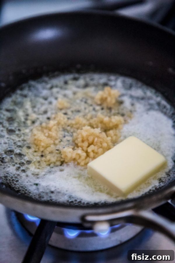 Spicy Cajun Salmon with Rich Garlic Parmesan Sauce 4 Garlic and butter sizzling in a skillet.