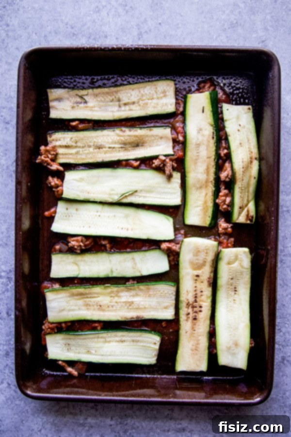 Tex-Mex Zucchini Lasagna 5 Layered Tex-Mex Zucchini Lasagna baking in a dish, showing its delicious layers
