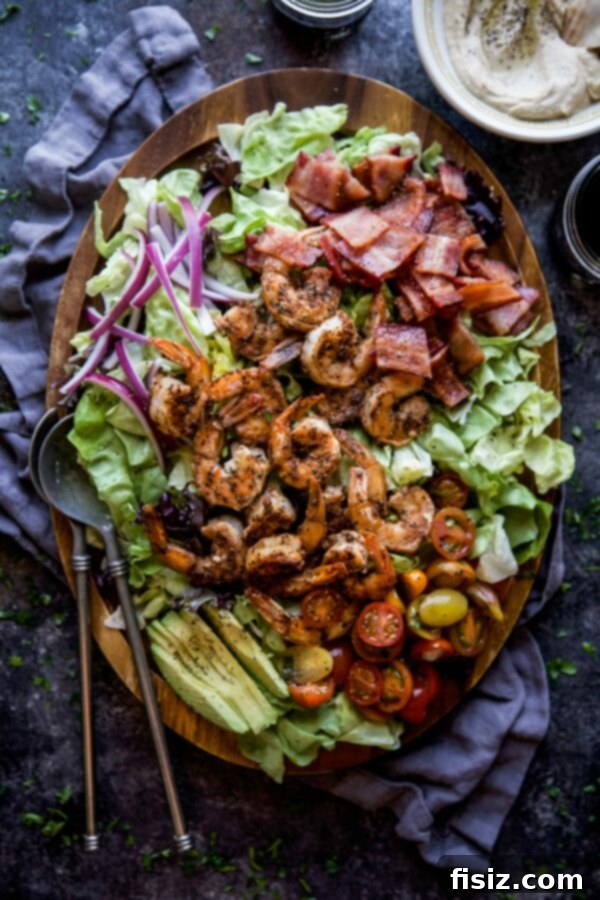 January's Creative Kickoff: My Must-Make List 4 A vibrant Turkish Shrimp BLT Salad served on a rustic plate, featuring grilled shrimp, crispy bacon, fresh lettuce, and ripe tomatoes