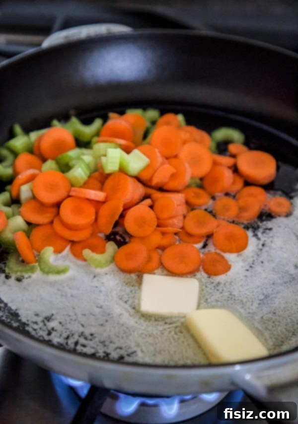 Gnocchi Chicken Pot Pie (Crustless) 4 Diced carrots and celery gently cooking in a cast iron skillet with melted butter.