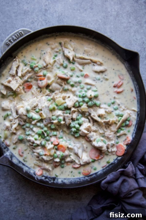 Gnocchi Chicken Pot Pie (Crustless) 5 Close-up of the rich and creamy chicken pot pie filling in a skillet before adding toppings.