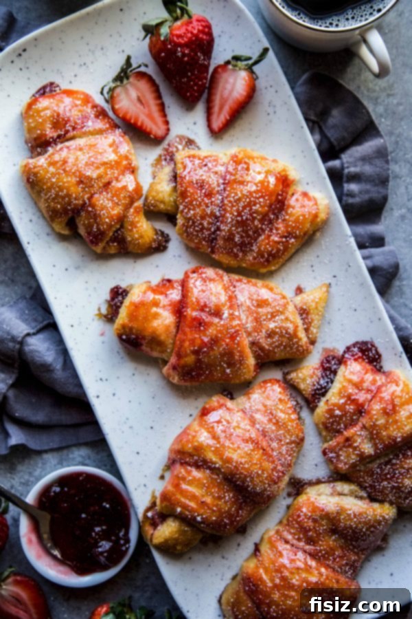 Sweet Strawberry Cardamom Croissants 6 A batch of Easy Strawberry and Cardamom Croissants freshly baked and presented on a rustic wooden tray