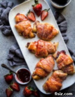 Sweet Strawberry Cardamom Croissants 7 A close-up of a single Easy Strawberry and Cardamom Croissant, showcasing its golden flakiness and delicious filling