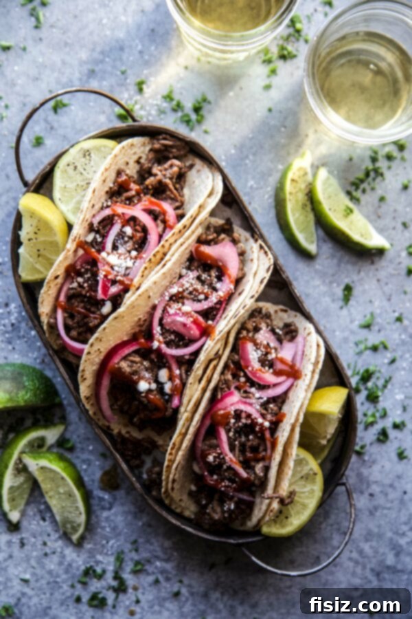 Sesame Beef Tacos with Tangy Pickled Onions 2 Sesame Beef Tacos with Quick Pickled Onions on a plate