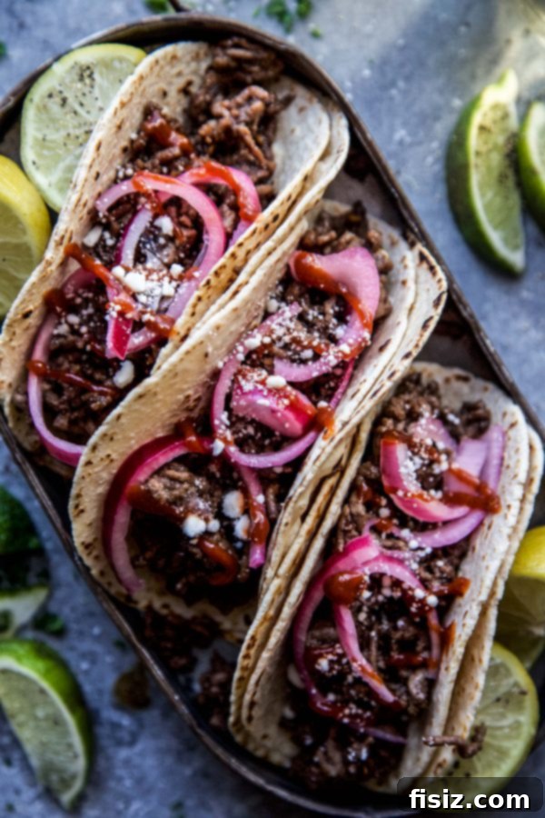 Sesame Beef Tacos with Tangy Pickled Onions 3 Sesame Beef Tacos with Quick Pickled Onions on a plate