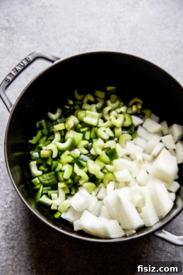 Chicken and Chorizo Gumbo: A Southern Classic 3 Close-up of chopped celery, onions, and green bell pepper in a skillet, representing the Cajun Holy Trinity.