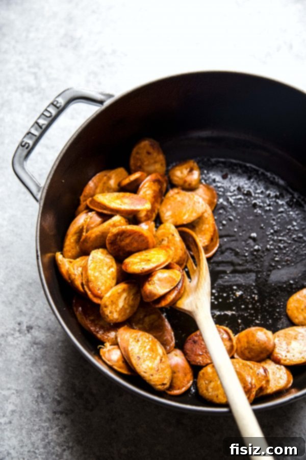 Chicken and Chorizo Gumbo: A Southern Classic 4 Sliced Spanish chorizo sizzling in a skillet, ready to be added to the gumbo.