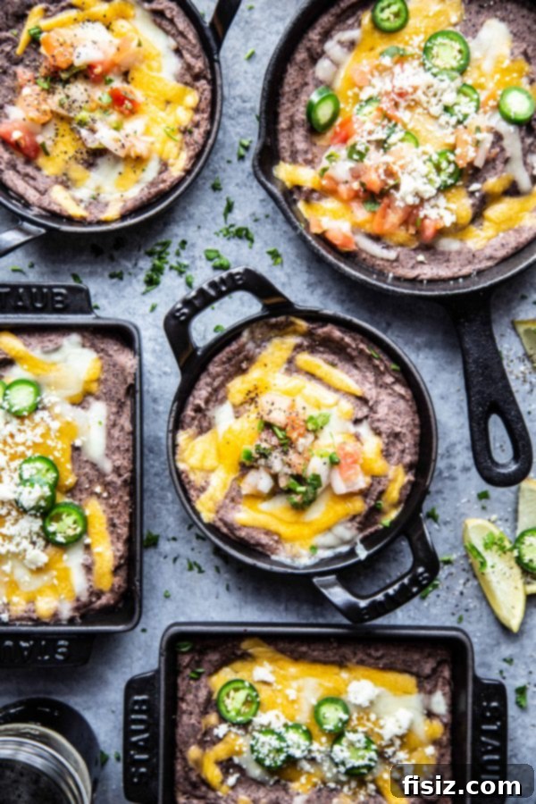 The Perfect Black Bean Dip 5 Ultimate Black Bean Dip in several skillets on a table